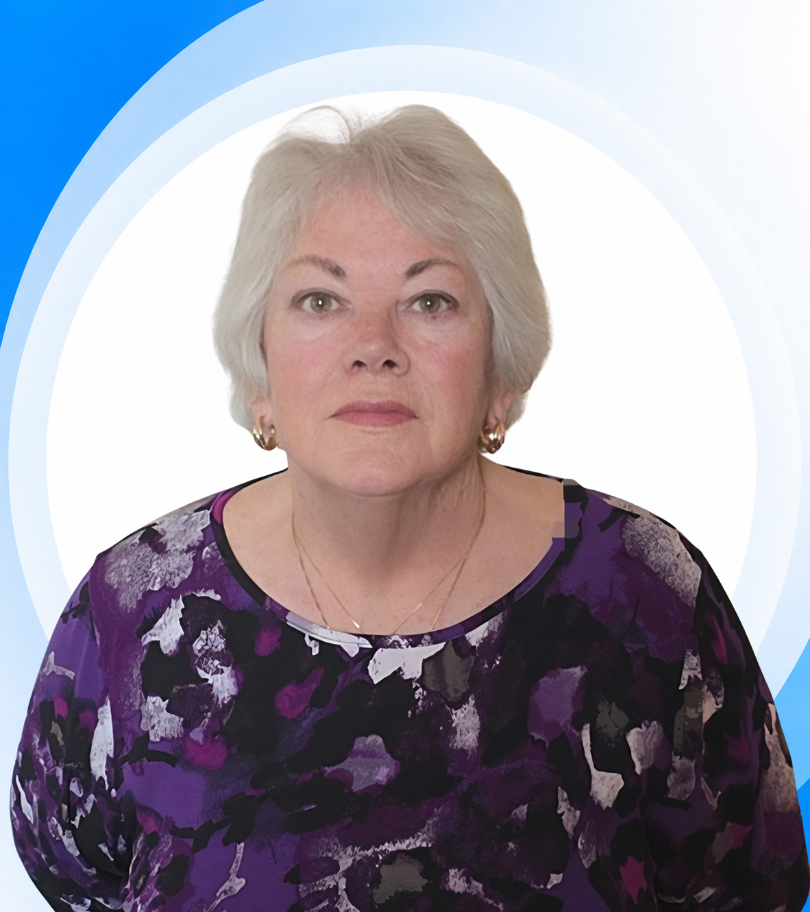 Older woman with gray hair in purple blouse